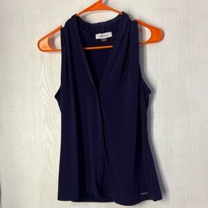 Dark purple sleeveless V-neck blouse made from a stretchy polyester blend. CK